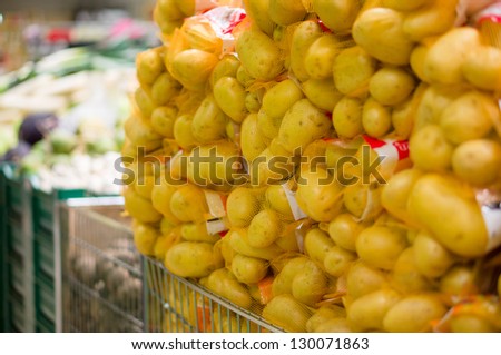 Bunch of potatoes in fence bags in supermarket