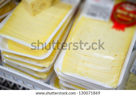 Cheese slices on shelves in supermarket