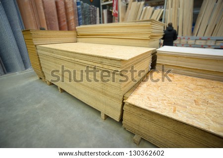 Plywood of different sizes lie on racks and pallets in build supermarket
