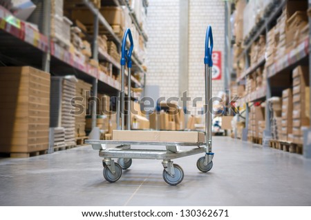 Freight trolley with box on it on modern warehouse