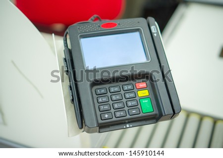 Card payment terminal at cash desk in supermarket