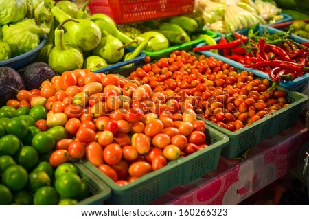Limes, tomatoes, peppers on city market in asia