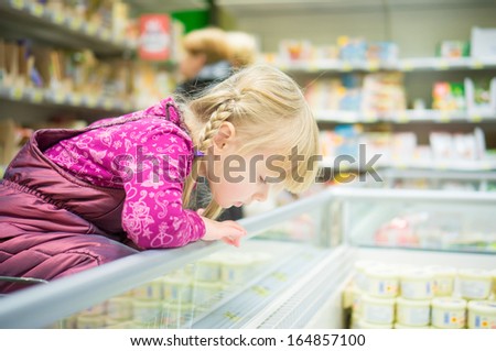 Adorable Girl Select Products At Fridge In Supermarket