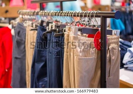 Variety of Sport trousers on stand in store