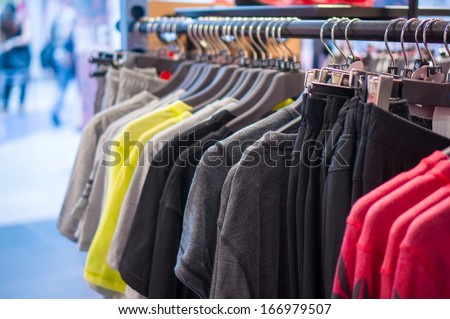 Variety of Sport t-shirts and trousers  on stand in store