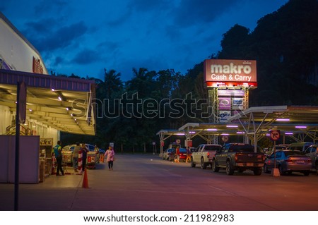 Krabi, 9 July 2014: Makro Cash and Carry shop entrance and parking lot on sunset at Krabi Town, Krabi province, Thailand.