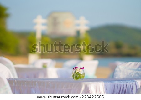 Luxury beach restaurant with tables and chairs covered with white cloth on tropical beach island