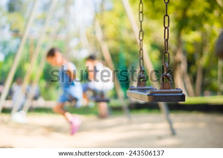 Set of chain swings on modern kids playground, kids swinging on back