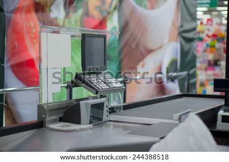 Empty cash desk with computer terminal in supermarket
