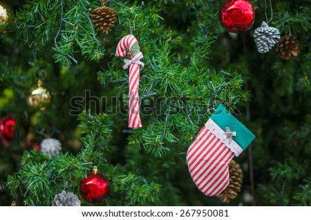 New year and christmas decorated tree. Color balls, cones, candy stick and sock