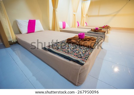 Spa massage setting with pillows and mattresses in massage room