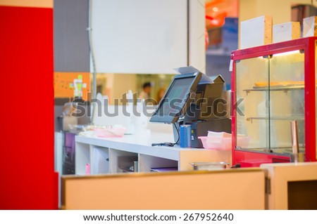 Empty cash desk with terminal in fast food restaurant in mall