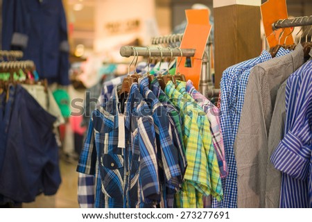 Different color pattern stripes short sleeve shirts on hangers in clothes store