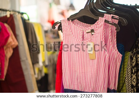 Different color and pattern dresses on hangers in cloth store