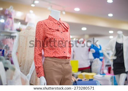 Everyday dressed woman mannequin with red blouse and trousers in store