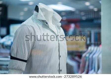 Mannequins in white striped shirts in clothes store