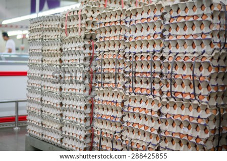 Stacked egges in trays in a rows in supermarket