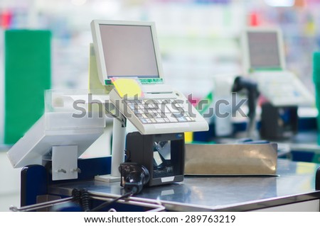 Empty cash desk with computer terminal in supermarket