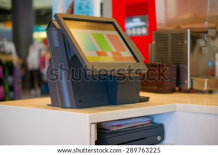 Empty cash desk terminal with computer touch screen in cafe