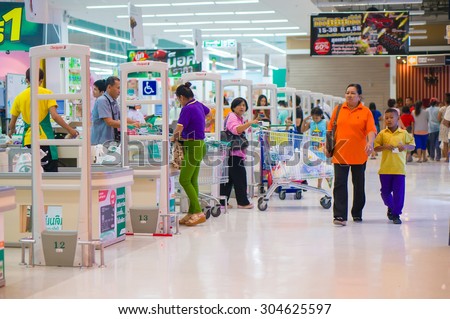 Songkhla, 26 june 2015: Row of cash desks with cashiers serves customers in Tesco Lotus Extra hypermarket in Songkhla, Songkhla province, Thailand.