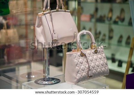 Woman luxury leather bag on table in store