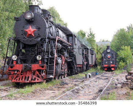 Two old locomotives with red stars