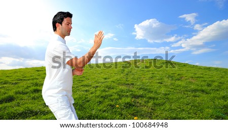 Man in white cloth in the morning meditating at hill background