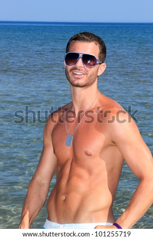 Portrait of cute young man on the beach