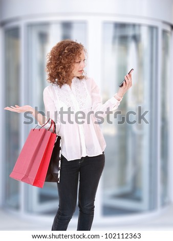 Modern woman shopping in mall holding bags