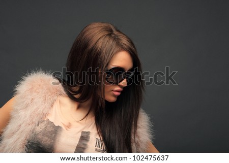 young woman portrait with big fashion sunglasses, studio shot