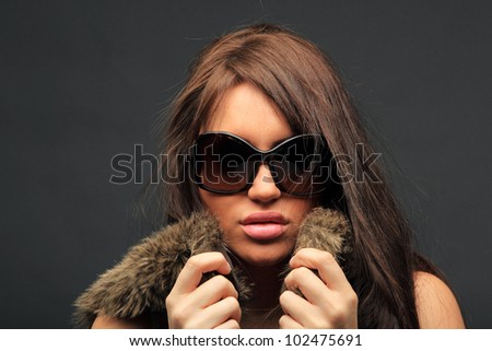 young woman portrait with big fashion sunglasses, studio shot