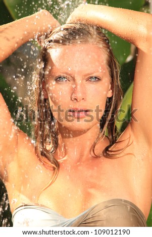 woman in tropical shower with palm and banana trees