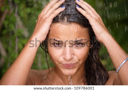woman in tropical shower with palm and banana trees