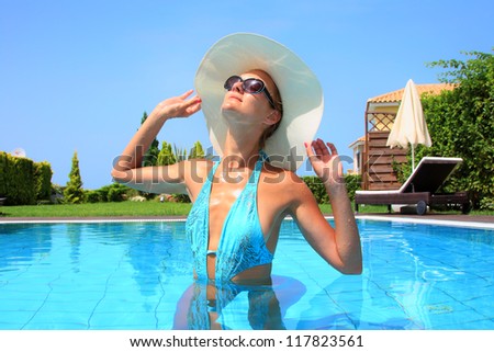 female in swimming pool enjoying her summer vacation