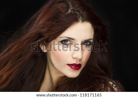 sensual brunette woman with shiny silky hair studio shot