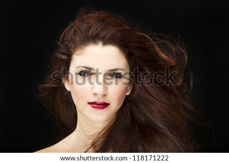 sensual brunette woman with shiny silky hair studio shot