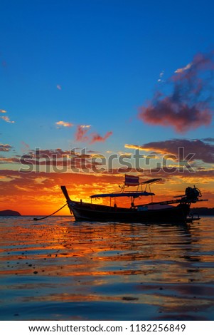 Rawai beach with andaman long tailed boat southern of thailand floating on clear sea water with sun shine in phuket