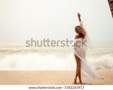 Woman enjoying serene ocean nature during travel holidays vacation outdoors.