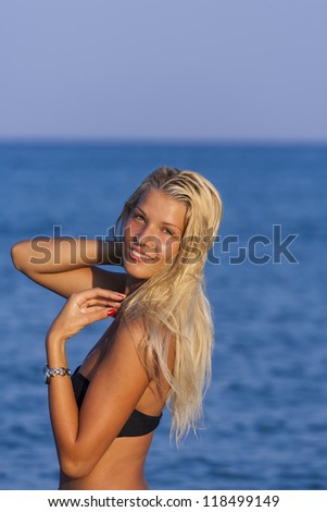 Blonde in the water waving and splashing water