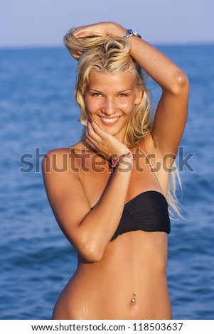 Blonde in the water waving and splashing water