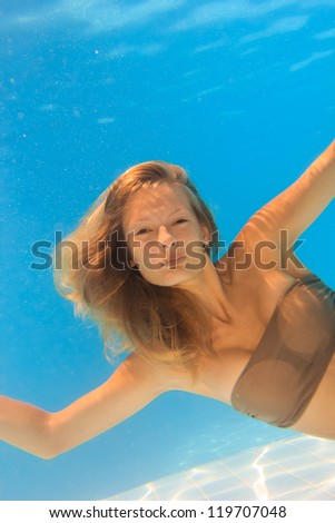 Young woman underwater in the swimming pool