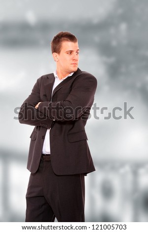 Cool businessman standing on light  background