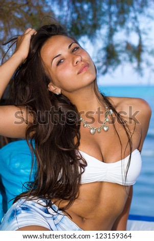 Beautiful young woman jeans shorts and bikini top