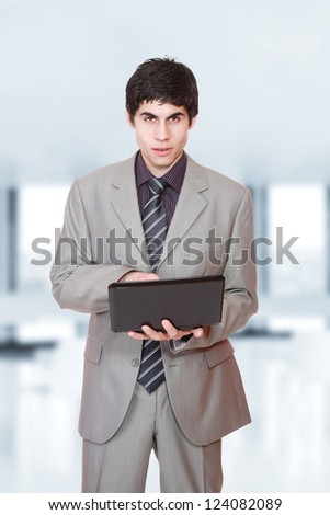 young Business man at the office holding a laptop computer