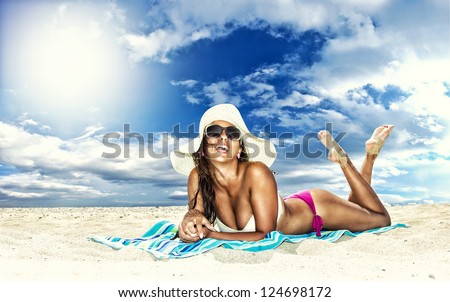 Beautiful Young Woman In Bikini Laying On The Beach