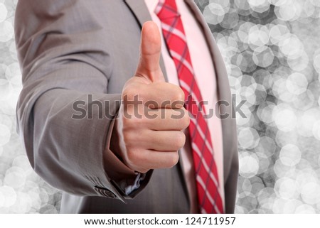 Business man thumb up over abstract background
