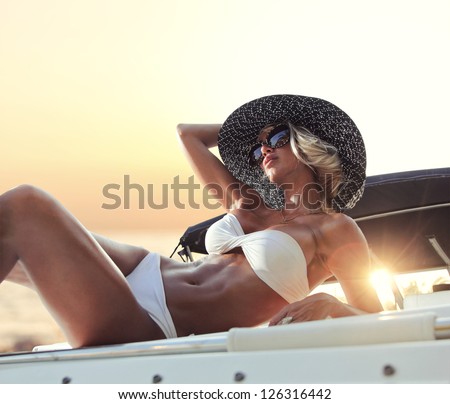 Young Sexy Woman In White Bikini Enjoying The Sunset On Her Private Yacht