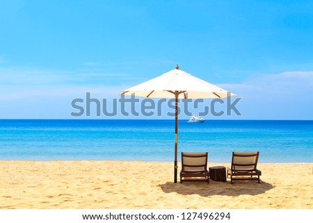 beds and umbrella on a tropical beach