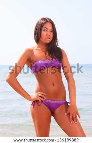 Beautiful young asian woman in bikini on the beach