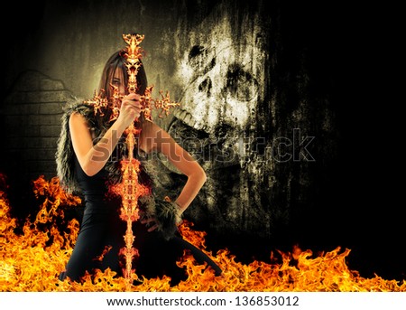 Warrior woman holding a fire sword with skull on background